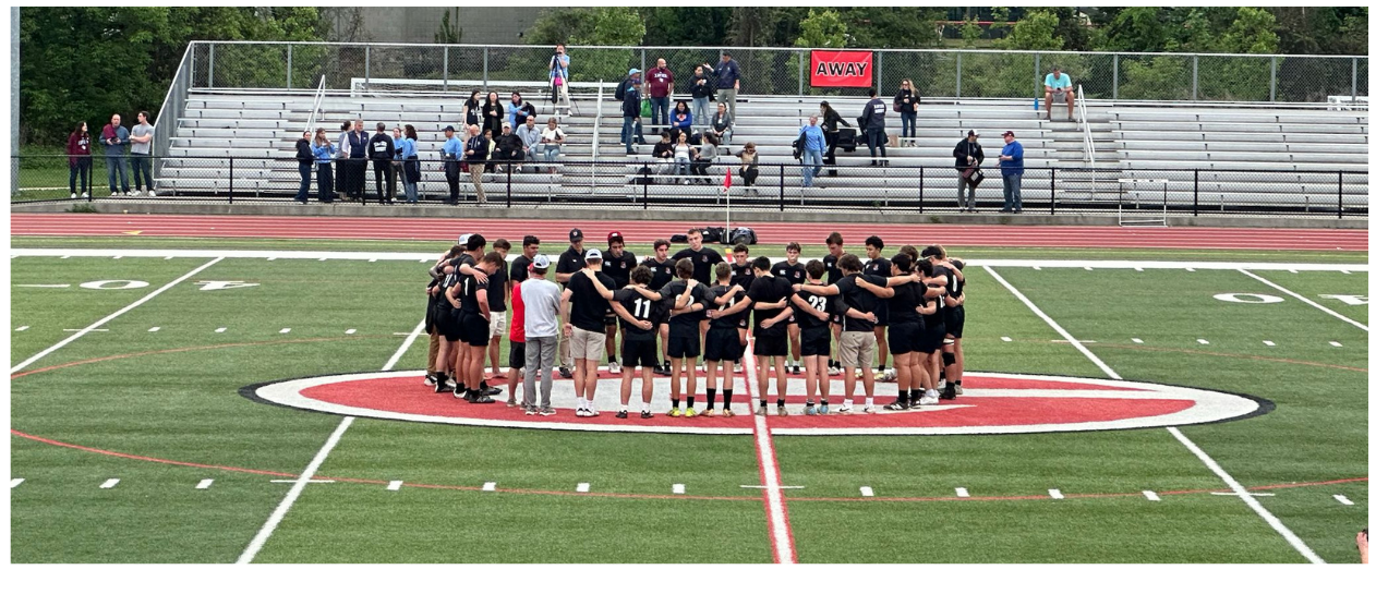 Rye Rugby team huddle at midfield